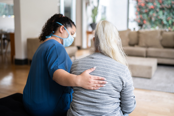 A social worker comforting a patient