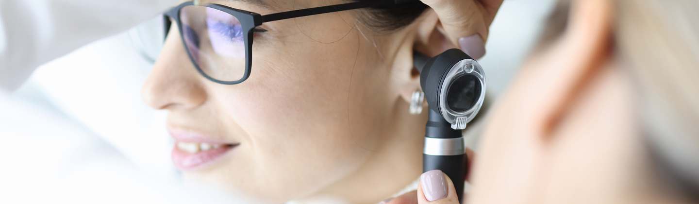 Doctor looking in patient ear