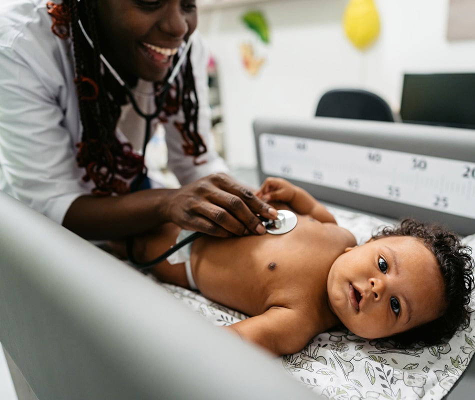 Pediatrician examining baby