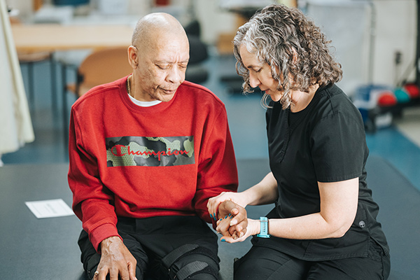 Patient having their hand worked on by provider