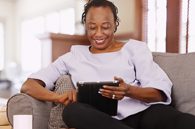 Woman on couch with computer talking to physician